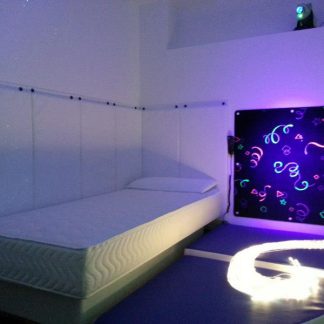Padding around a bed within a sensory room designed by us: